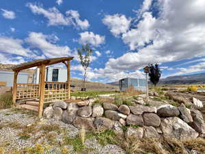 View of property's community with a mountain view and an outdoor structure