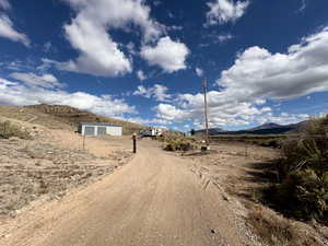 View of dirt / gravel driveway with a mountain view