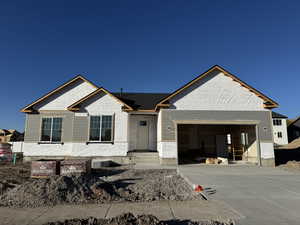 Property in mid-construction featuring driveway and an attached garage
