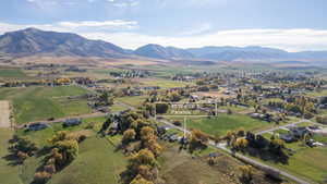 Aerial view of property's location with a mountainous background and rural landscape