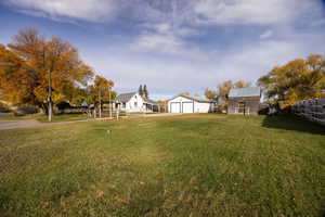 View of yard with an outdoor structure and a garage