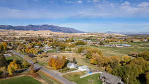 Aerial view of property's location featuring a mountainous background