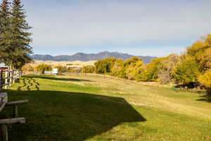 View of yard featuring a rural view and a mountain view