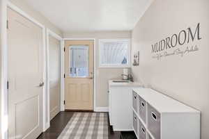 Laundry room featuring dark wood finished floors and a sink