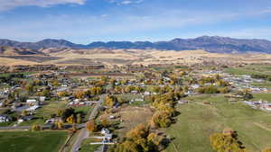Aerial view of property's location featuring a mountainous background