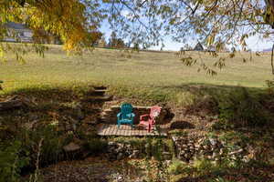 View of yard with a wooden deck and a view of rural / pastoral area