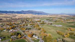 Aerial view of property's location with a mountainous background and rural landscape