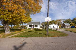 Bungalow-style house featuring an outbuilding and a detached garage