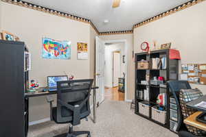 Office with light colored carpet and ceiling fan