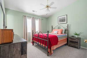 Bedroom featuring carpet flooring, lofted ceiling, and ceiling fan