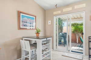 Dining room featuring light carpet and baseboards