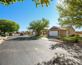 View of front of home featuring a residential view, concrete driveway, and an attached garage