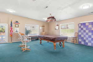 Playroom with plenty of natural light, billiards, and lofted ceiling