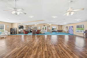 Misc room with ceiling fan, billiards table, lofted ceiling, and a textured ceiling