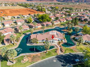 Aerial overview of property's location featuring a nearby body of water and nearby suburban area