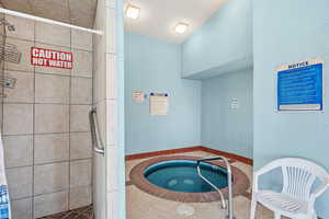 View of swimming pool with an in-ground hot tub