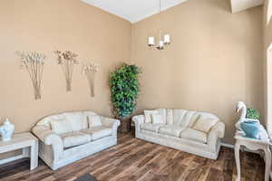 Living room featuring wood finished floors and a chandelier