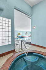 View of swimming pool featuring a swimming pool and an in-ground hot tub