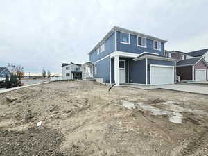 View of property exterior featuring an attached garage and concrete driveway
