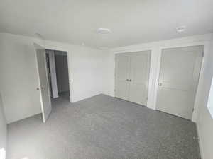 Unfurnished bedroom with carpet and a closet
