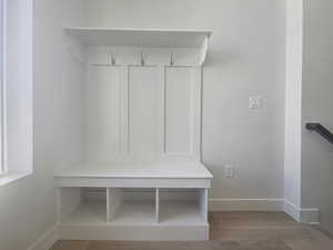 Mudroom with baseboards and light wood-type flooring