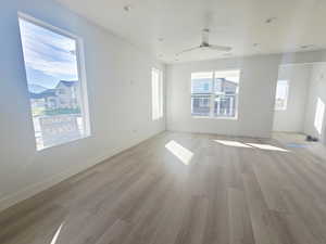 Spare room featuring light wood-style flooring, ceiling fan, and recessed lighting
