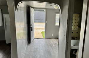 Entryway featuring wood finished floors and arched walkways