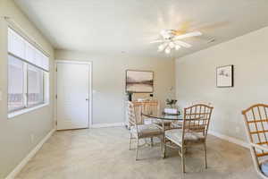 Dining area with a textured ceiling and a ceiling fan