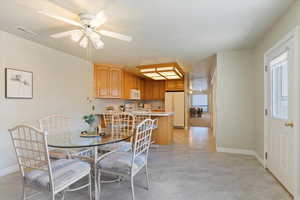 Dining area featuring healthy amount of natural light, ceiling fan, and a textured ceiling
