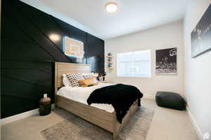 Carpeted bedroom with baseboards