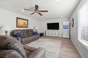 Living area featuring light wood-style flooring, recessed lighting, and ceiling fan