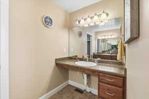 Bathroom featuring light tile patterned flooring and vanity