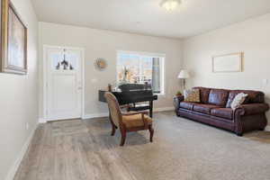 Living room featuring baseboards and light wood finished floors