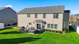 Back of house featuring a patio area and roof with shingles