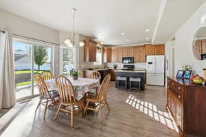 Dining room with recessed lighting, a chandelier, and light wood-type flooring