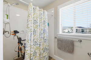 Full bathroom with curtained shower
