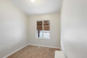 Unfurnished room with carpet floors and baseboards