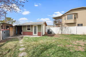 Fenced backyard with a balcony