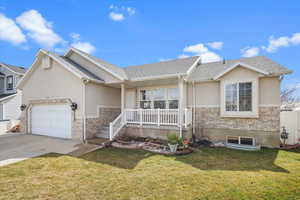 Ranch-style home with stucco siding, a front lawn, an attached garage, and concrete driveway