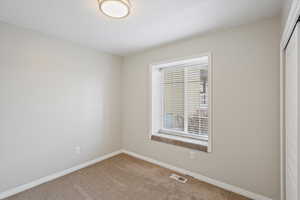 Unfurnished room featuring baseboards and carpet flooring