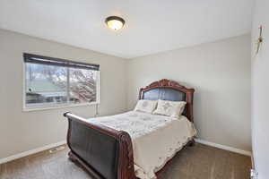 Carpeted bedroom featuring baseboards