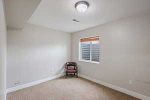 Unfurnished room featuring baseboards and carpet