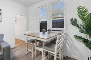Dining space with baseboards and wood finished floors