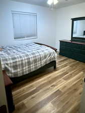 Bedroom featuring wood finished floors and a ceiling fan