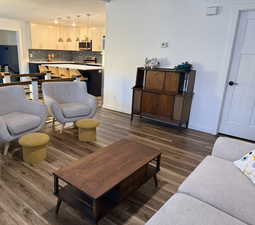 Living area featuring dark wood-style floors and a textured ceiling