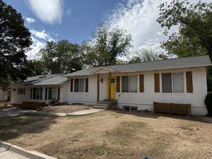 Single story home featuring a shingled roof, board and batten siding, and entry steps