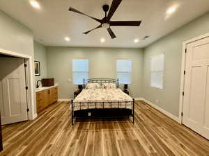Bedroom with recessed lighting, a ceiling fan, and light wood-style floors