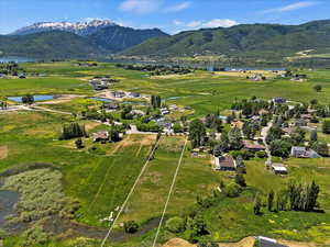 Aerial view of property and surrounding area with a water and mountain view