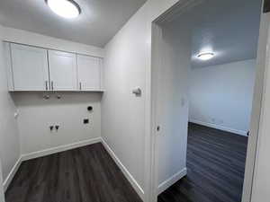 Laundry room featuring dark wood finished floors, cabinet space, hookup for an electric dryer, gas dryer hookup, and hookup for a washing machine