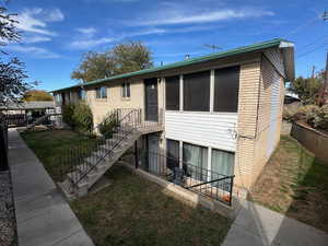 View of front of property with brick siding and stairs